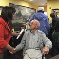 Susan Moore, left, with the Office of Human Concern, greets lifelong Lowell resident Elza Tucker on ...