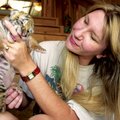 Tanya Smith, one of the founders of Turpentine Creek Wildlife Refuge near Eureka Springs, greets a n...