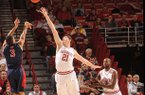 NWA Media/ANDY SHUPE -- Robert Morris junior guard Coron Williams (3) takes a 3-point shot over Arkansas sophomore forward Hunter Mickelson (21) during the first half Thursday, Dec. 20, 2012, in Bud Walton Arena in Fayetteville.