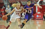 NWA Media/MICHAEL WOODS --12/21/2012-- Arkansas' Erin Gatling tries to get the ball past Northwestern State defender Janelle Perez as she drives to the hoop in the first half of Friday night's game at Bud Walton Arena in Fayetteville.