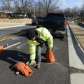 Brady Burcham of Time Striping removes the final roadblock Thursday to open the newly upgraded secti...