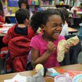 Samaria Hall, 6, gets excited about the gifts she received in a stocking Friday in her kindergarten ...