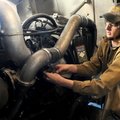 Jacob Little with the diesel technology class at Northwest Technical Institute in Springdale checks ...