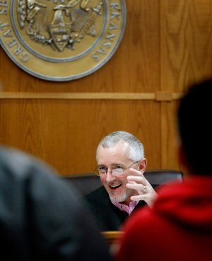 Ernest Cate, Springdale District Court judge, speaks Thursday to people appearing in the court. 