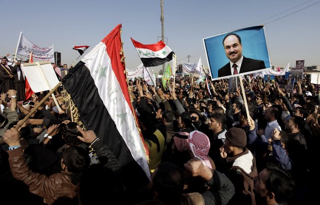 protesters-chant-slogans-against-the-iraqs-shiite-led-government-as-they-wave-national-flags-and-hold-posters-of-the-sunni-finance-minister-rafia-al-issawi-during-a-demonstration-in-fallujah-40-miles-west-of-baghdad-iraq-sunday-dec-12-2012-thousands-of-protesters-have-demonstrated-in-iraqs-western-sunni-heartland-following-the-arrest-of-bodyguards-assigned-to-the-finance-minister-who-draws-support-from-the-area