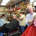 Richard Howk, right, gets a trim from barber Gary Townzen on Saturday during Townzen’s annual charit...