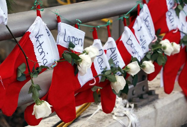 file-in-this-wednesday-dec-19-2012-file-photo-christmas-stockings-with-the-names-of-shooting-victims-hang-from-railing-near-a-makeshift-memorial-near-the-town-christmas-tree-in-the-sandy-hook-village-of-newtown-conn-in-the-wake-of-the-shooting-the-grieving-town-is-trying-to-find-meaning-in-christmas-ap-photojulio-cortez-file