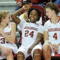 Arkansas players Melissa Wolf, Quistelle Williams and Sarah Watkins relax on the bench for the final...