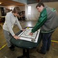 Tanner Wilson, left, and Brandon Fulton, Greenland High School juniors, take a look at the plans for...
