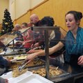 Meredith Hedberg, right, serves turkey on Tuesday during the Central United Methodist Church of Roge...