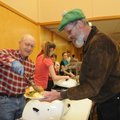Ed Grames, left, serves a traditional Christmas dinner to John J.C. Colbert on Tuesday at Central Un...