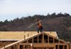 A worker installs roofing material on a house under construction at Davidson Communities LLC's Arista at The Crosby development in Rancho Santa Fe, California, U.S. on Friday, Dec. 21, 2012. New home sales climbed to a 380,000 annual rate in November, the most since April 2010, according to the median forecast of 60 economists surveyed by Bloomberg before Dec. 27 figures from the Commerce Department. Photographer: Sam Hodgson/Bloomberg
