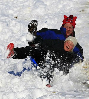 
Matt Blunt and his daughter Abby sled down a hill Wednesday morning in Maumelle.  A historic Christmas night winter storm dropped upwards of a foot of snow on parts of Arkansas, shutting down workplaces, downing trees and power lines and turning travel treacherous. As of Wednesday afternoon more than 182,000 Entergy customers were without electricity. More than 90,000 of those were in Pulaski County.