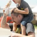 Chris Ravenscroft of Fayetteville holds an ice cream cone Thursday, Aug. 30, 2012, for his 3-year-ol...