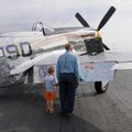 Ervin Hutchins, right, and his great-grandson Elijah Jones, 4, look at a P-51 Mustang Monday, Sept. ...