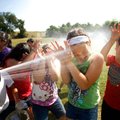 Lowell Elementary fourth-grader Brooklyn Beebe covers her face while she and fellow classmates take ...