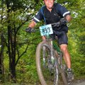 A competitor in the 2012 Northwest Arkansas Mountain Bike Championship tops a hill at Devil's Den St...