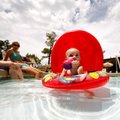 McKayla Cawood, 14 months, floats around in the pool at Paradise Valley Golf & Athletic Club in Faye...