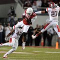Arkansas wide receiver Brandon Mitchell catches the ball between Rutgers linebacker Steve Beauharnai...