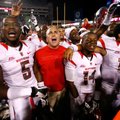 Rutgers head coach Kyle Flood and players celebrate following their 35-26 win over Arkansas on Satur...