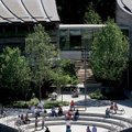 Students frolic outdoors after taking a tour of the Crystal Bridges Museum of American Art in Benton...