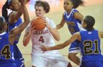 Arkansas forward Sarah Watkins drives to the hoop between Coppin State defenders (left to right) LArrisa Carter, Kyra Coleman, Amber Grifin and Shawntae Payne during the first half of Friday night's game at Bud Walton Arena in Fayetteville.