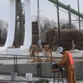 Everett Hice installs railings Thursday near one of the water slides at the Rogers aquatic center un...