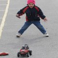 David Tumbleson, 3, plays with a remote control car Thursday in the Elmdale Elementary School parkin...