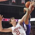 University of Arkansas forward Hunter Mickelson and Northwestern State forward DeQuan Hicks fight fo...