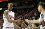 Arkansas guard BJ Young gets high fives from his teammates as he leaves the game late in the second half of Saturday night's game against Northwestern State. Young and Hunter Mickelson each finished with a career-high 13 rebounds.