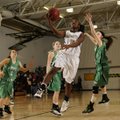 Bentonville’s Jamayne Potts, center, takes the ball to the basket past Pierce City (Mo.) defender Sh...