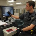 Deputy Mike Nugent shows on Friday how the Benton County Jail’s fingerprinting equipment works. 