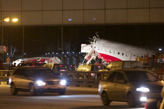 cars-travel-past-the-wreckage-of-a-plane-that-careered-off-the-runway-at-vnukovo-airport-in-moscow-saturday-dec-29-2012-a-tu-204-aircraft-belonging-to-russian-airline-red-wings-careered-off-the-runway-at-russias-third-busiest-airport-on-saturday-broke-into-pieces-and-caught-fire-killing-several-people