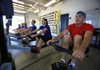 Arkansas Boathouse Club crews practice moving in sync even when exercising indoors on their ergometers. (From left) Amy Ballard, Yates Phillips, Eileen Denne, Jim Smith, Megan Birtson and Steve Denne go through the motions of a typical weekday winter-conditioning workout. 