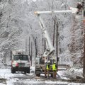 An Entergy Arkansas Inc., crew works to restore power to customers on Whittington Avenue near the en...