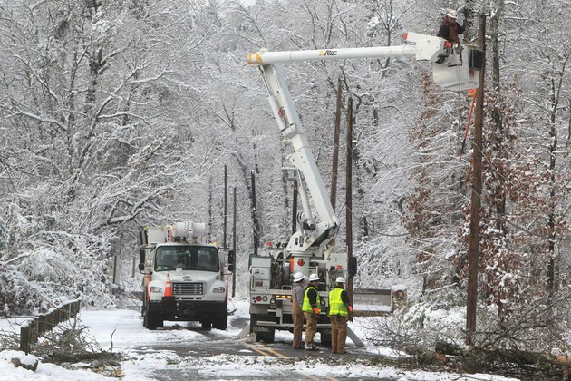 an-entergy-arkansas-inc-crew-works-to-restore-power-to-customers-on-whittington-avenue-near-the-entrance-to-hot-springs-national-park-thursday-dec-27-2012-in-hot-springs-ark