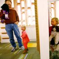 Olivia Rojeski, right, 3, totes a cat puppet and peers through the curtain as her sister, Abbey Roje...