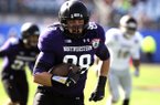 Northwestern defensive lineman Quentin Williams (88) returns a interception for a touchdown during the first half of the Gator Bowl NCAA college football game against Mississippi State, Tuesday, Jan. 1, 2013, in Jacksonville, Fla. (AP Photo/Stephen Morton)