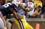 Auburn defensive end Corey Lemonier causes LSU quarterback Zach Mettenberger to fumble during the first half Sept. 22. Auburn recovered the fumble. (Associated Press)