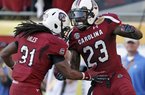South Carolina wide receiver Bruce Ellington (23) celebrates with teammate Kenny Miles (31) after scoring on a 32-yard touchdown reception during the second half of the Outback Bowl NCAA college football game against Michigan, Tuesday, Jan. 1, 2013, in Tampa, Fla. South Carolina won 33-28. (AP Photo/Chris O'Meara)