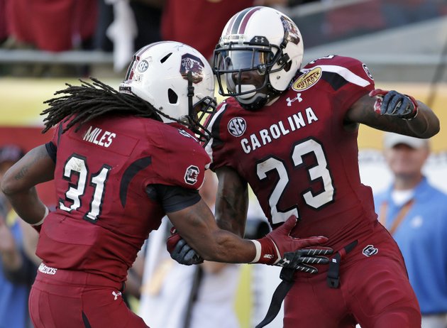 south-carolina-wide-receiver-bruce-ellington-23-celebrates-with-teammate-kenny-miles-31-after-scoring-on-a-32-yard-touchdown-reception-during-the-second-half-of-the-outback-bowl-ncaa-college-football-game-against-michigan-tuesday-jan-1-2013-in-tampa-fla-south-carolina-won-33-28-ap-photochris-omeara