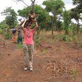 Sara Steinlage carries firewood as part of her chores at the Go Women Go Community group in Mpomgwe,...