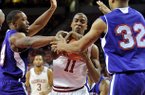 NWA Media/MICHAEL WOODS --12/29/2012-- Arkansas guard BJ Young tries to fight off Northwestern State defenders Gary Robertson and DeQuan Hicks for the rebound during the first half of Saturday night's game at Bud Walton Arena in Fayetteville.