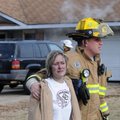 Mike Pellegrino, right, a Springdale firefighter, escorts a girl to an ambulance Wednesday while cre...