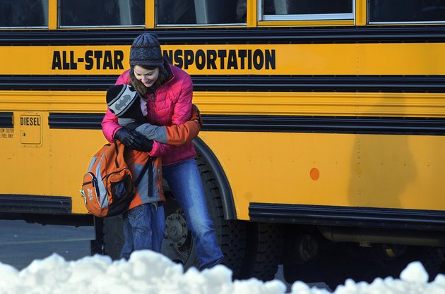 a-woman-hugs-a-child-before-he-boards-a-bus-on-the-first-day-of-classes-after-the-holiday-break-in-newtown-conn-on-wednesday-jan-2-2013-children-from-sandy-hook-elementary-school-returned-to-school-thursday-in-the-neighboring-town-of-monroe
