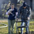 Kim Benham, left, leads John Logston and his dog “Tuffy” away from his home Thursday as Bentonville ...