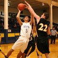  Decatur sophomore forward Mario Urquidi takes a shot under the basket over Hackett's Buddy Nichols ...