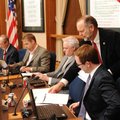 Kit Williams, standing, city attorney, passes out material to Alan T. Long and other members of the ...