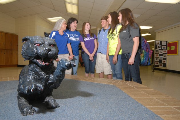 conway-high-school-teachers-beth-white-from-the-left-and-jeani-johnson-along-with-former-students-natalie-faught-corey-robichaud-christina-johnson-and-cheyanne-sutton-chat-in-part-of-the-old-conway-high-school-before-its-demolition-near-a-small-statue-of-the-schools-mascot-the-wampus-cat-an-unveiling-of-a-6-foot-tall-bronze-wampus-cat-statue-is-scheduled-for-4-pm-tuesday-in-front-of-the-james-h-clark-auditorium-on-the-new-high-school-campus