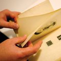 Jason Dean, cataloger and technical services librarian, shows the uncut pages in a rare copy of “The...